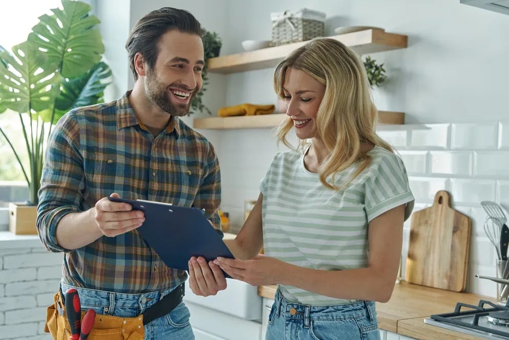 Home inspector reviewing a checklist with a homeowner, highlighting common red flags found during home inspections.