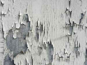 Peeling and deteriorating interior wall paint, a common warning sign buyers may notice during a home inspection.