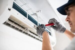 Technician servicing an HVAC unit, highlighting common heating and cooling issues found during home inspections.